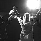 Slow motion of actors and actresses bowing to audience in a theater